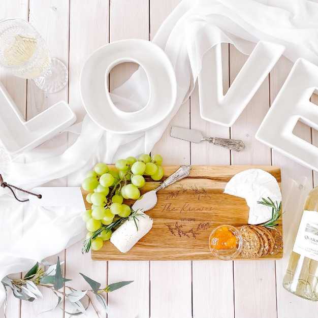 inspiration - "LOVE" plates set on a table alongside a charcuterie board and wine