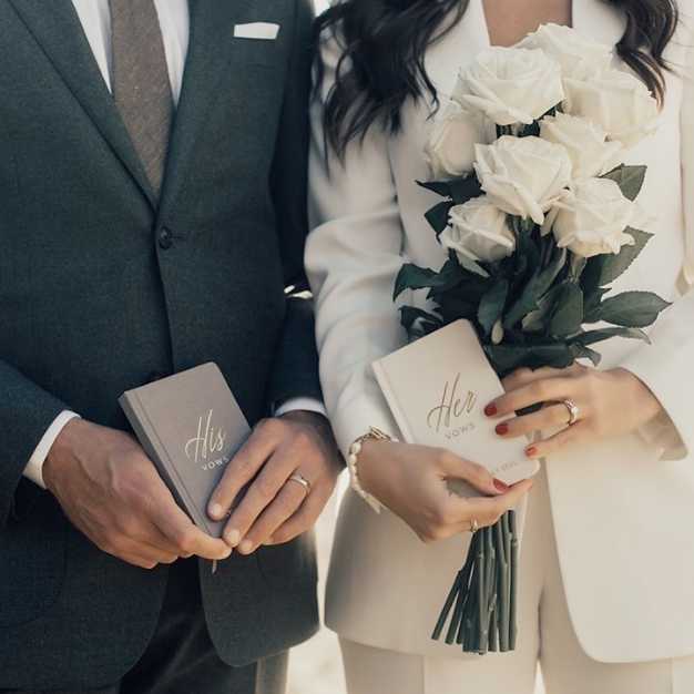 inspiration - a bride and groom each holding a vow journal